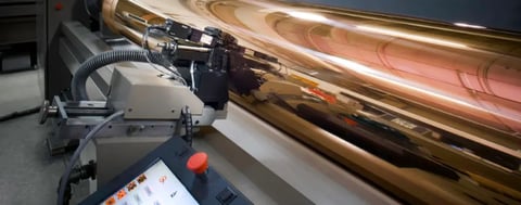 Gravure print cylinder transferring high-fidelity images in commercial printing.